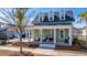Charming home with inviting front porch, dormer windows and lush landscaping at 411 Watergrass Way, Summerville, SC 29485