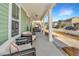 Inviting front porch, decorated with comfortable seating, perfect for relaxing outdoors at 411 Watergrass Way, Summerville, SC 29485