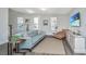 Bright living room features a comfortable blue sofa and modern decor with a view to the stairs at 411 Watergrass Way, Summerville, SC 29485
