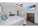 Bedroom with a ceiling fan, TV, neutral walls, and french doors leading to a balcony at 411 Watergrass Way, Summerville, SC 29485