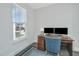Home office with wood desk, comfortable blue chair and natural light from window at 411 Watergrass Way, Summerville, SC 29485