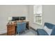 Home office with wood desk, comfortable blue chair and natural light from window at 411 Watergrass Way, Summerville, SC 29485