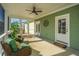 Cozy screened porch with rattan chairs, lush cushions, and a ceiling fan for relaxed outdoor living at 411 Watergrass Way, Summerville, SC 29485