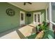 Inviting screened porch with comfortable seating, ceiling fan and an outdoor television at 411 Watergrass Way, Summerville, SC 29485