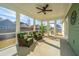 Charming screened porch with wicker furniture and a ceiling fan, perfect for enjoying the outdoors at 411 Watergrass Way, Summerville, SC 29485