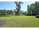 Lush backyard with pond views surrounded by mature trees offering privacy at 4162 Ten Shillings Way, Hollywood, SC 29470