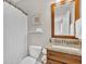 Well-lit bathroom with a sink, vanity, toilet, and a shower with white curtain at 4162 Ten Shillings Way, Hollywood, SC 29470