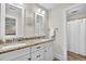 Elegant bathroom featuring double sinks, granite countertops, white cabinetry and walk-in shower at 4162 Ten Shillings Way, Hollywood, SC 29470