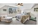 Cozy bedroom with a ceiling fan, comfortable bed, scenic view through the window and accent chair at 4162 Ten Shillings Way, Hollywood, SC 29470