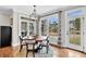 Cozy dining area with views of the water and lush landscaping through large windows at 4162 Ten Shillings Way, Hollywood, SC 29470