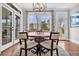 Cozy dining area with views of the water and lush landscaping through large windows at 4162 Ten Shillings Way, Hollywood, SC 29470