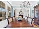 Dining room featuring wooden table and chairs, chandelier, hutch, and large windows at 4162 Ten Shillings Way, Hollywood, SC 29470