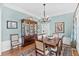 Dining room featuring a wooden table, chairs, hutch, chandelier, and light blue walls at 4162 Ten Shillings Way, Hollywood, SC 29470