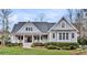 Lovely home with a welcoming front porch, well-maintained landscaping, and classic architectural details at 4162 Ten Shillings Way, Hollywood, SC 29470