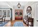 Welcoming foyer featuring a wooden front door, console table, light fixture, and a stylish blue rug at 4162 Ten Shillings Way, Hollywood, SC 29470