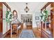 Inviting foyer with hardwood floors, a decorative table, and an open view to the living room, creating a warm welcome at 4162 Ten Shillings Way, Hollywood, SC 29470