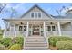 Attractive home with a large front porch, double doors and manicured landscaping. Address is displayed above the door at 4162 Ten Shillings Way, Hollywood, SC 29470
