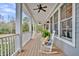 Inviting front porch featuring comfortable seating, ceiling fans, and views of the surrounding landscape at 4162 Ten Shillings Way, Hollywood, SC 29470