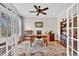 Bright home office featuring hardwood floors, built-in shelving, and a ceiling fan at 4162 Ten Shillings Way, Hollywood, SC 29470