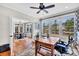 Bright home office featuring hardwood floors, built-in shelving, and large windows at 4162 Ten Shillings Way, Hollywood, SC 29470