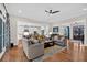 Open-concept living room featuring sofas, hardwood floors, and an open view to the kitchen at 4162 Ten Shillings Way, Hollywood, SC 29470