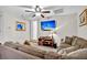Inviting living room featuring a ceiling fan, mounted flat screen, and comfortable seating at 4162 Ten Shillings Way, Hollywood, SC 29470