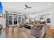 Bright, open living room with a ceiling fan, sofas, and access to both the kitchen and patio at 4162 Ten Shillings Way, Hollywood, SC 29470
