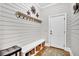 Charming mudroom with shiplap walls, coat hooks, bench, storage and a convenient entrance to the home at 4162 Ten Shillings Way, Hollywood, SC 29470