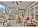 Spacious screened porch with outdoor seating and a view of the surrounding trees at 4162 Ten Shillings Way, Hollywood, SC 29470