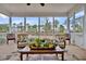 Screened porch area with outdoor seating overlooking the lake at 4162 Ten Shillings Way, Hollywood, SC 29470