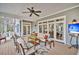 Relaxing screened porch with ceiling fan and comfortable seating area at 4162 Ten Shillings Way, Hollywood, SC 29470