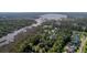 A sprawling aerial view showcasing the community with lush greenery and waterfront access at 4385 Ten Shillings Way, Hollywood, SC 29470