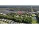 Stunning aerial view of a house on a riverfront property surrounded by lush greenery and a tranquil waterway at 4385 Ten Shillings Way, Hollywood, SC 29470