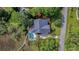 Aerial view of the home showing pool, spa, and surrounding landscape with a nearby road at 4385 Ten Shillings Way, Hollywood, SC 29470