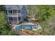 Stunning aerial view of a charming blue house, complete with pool, jacuzzi, patio, and a scenic boardwalk at 4385 Ten Shillings Way, Hollywood, SC 29470