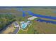Stunning aerial view of community pool and surrounding marshlands and waterways at 4385 Ten Shillings Way, Hollywood, SC 29470