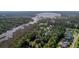 A sprawling aerial view showcasing the community with lush greenery and waterfront access at 4385 Ten Shillings Way, Hollywood, SC 29470