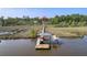Waterfront home and boat dock extending over marsh and water; convenient boat storage on lift at dock at 4385 Ten Shillings Way, Hollywood, SC 29470