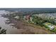 Aerial view of waterfront home with dock, surrounded by lush greenery and marshland, indicated by map marker at 4385 Ten Shillings Way, Hollywood, SC 29470