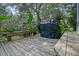 Outdoor deck features built-in bench seating, lush greenery, and covered grill for outdoor entertaining at 4385 Ten Shillings Way, Hollywood, SC 29470