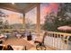 Relaxing covered porch offering seating area and picturesque sunset views at 4385 Ten Shillings Way, Hollywood, SC 29470