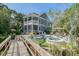 Beautiful backyard featuring a custom pool, hot tub, and lush landscaping for outdoor enjoyment at 4385 Ten Shillings Way, Hollywood, SC 29470