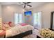 Cozy bedroom featuring a ceiling fan, mounted TV, and large windows for plenty of natural light at 4385 Ten Shillings Way, Hollywood, SC 29470