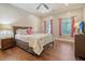 Cozy bedroom featuring hardwood floors, large bed, and lots of natural light at 4385 Ten Shillings Way, Hollywood, SC 29470