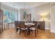 Formal dining room showcasing elegant decor and natural light from large windows at 4385 Ten Shillings Way, Hollywood, SC 29470