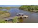 Beautiful wooden dock featuring boat lift with cover, walkway, and adjacent calm waterway at 4385 Ten Shillings Way, Hollywood, SC 29470