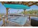 Waterfront covered boat dock with a boat lift, kayak and hammock overlooking a beautiful river at 4385 Ten Shillings Way, Hollywood, SC 29470