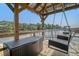 Waterfront covered dock with wicker furniture, chest, and porch swing overlooking a beautiful river at 4385 Ten Shillings Way, Hollywood, SC 29470