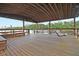 Covered dock with wooden floors features a swing overlooking the waterfront at 4385 Ten Shillings Way, Hollywood, SC 29470