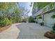 Driveway leading to a two-car garage with a pergola and flowering plants surrounding the house at 4385 Ten Shillings Way, Hollywood, SC 29470
